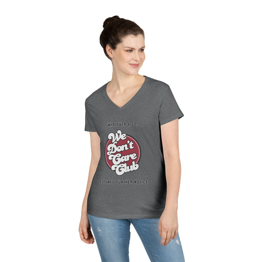 Woman wearing gray casual V-neck tee with "We Don't Care Club" text design, paired with jeans