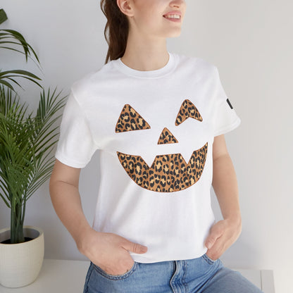 Woman wearing white Halloween tee with leopard print Jac O'Lantern pumpkin face design