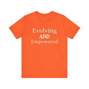 Unisex jersey short sleeve tee in orange with "Evolving and Empowered" text.