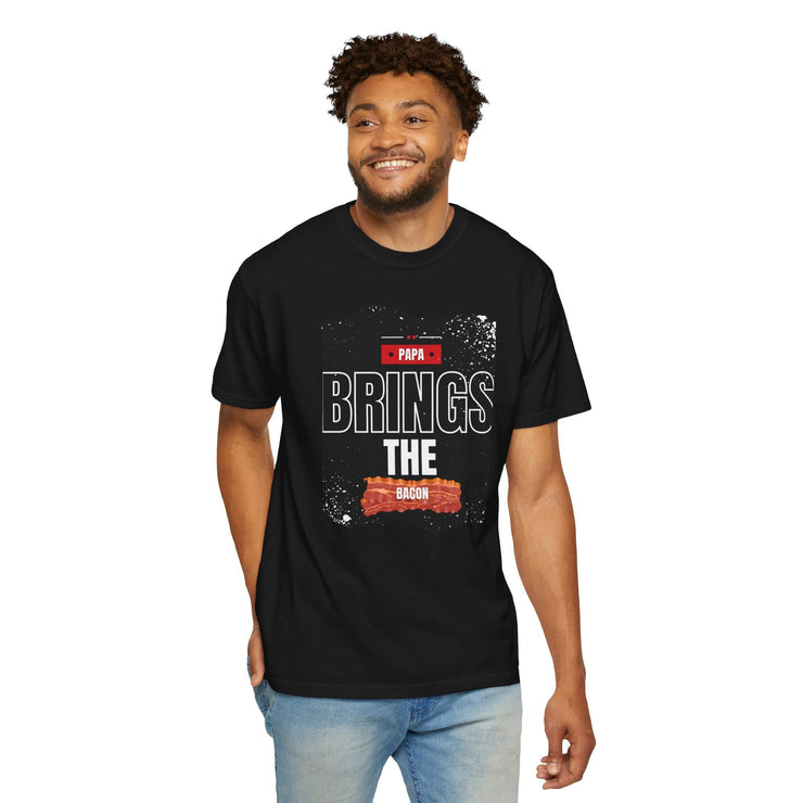 Unisex "Papa Brings the Bacon" garment-dyed T-shirt, perfect gift for dads, featuring fun and stylish design, available in sizes S to 4XL.