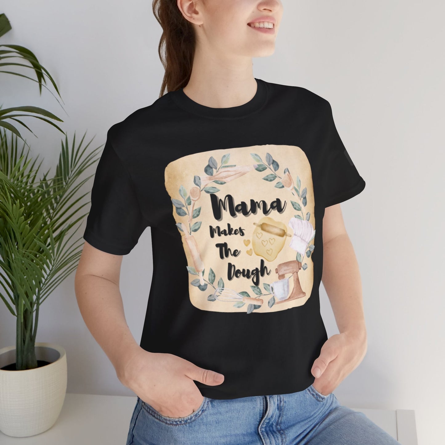 Black short sleeve shirt with "Momma Makes The Dough" cooking themed design, casual unisex tee perfect for baking lovers