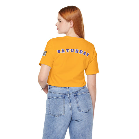 Woman wearing orange Day of the week Tee with "Saturday" text on the back and blue jeans