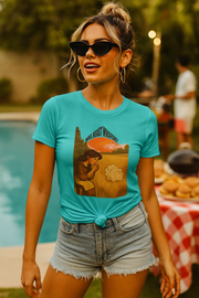 Woman wearing turquoise Wild Yeast Whisperer graphic boyfriend tee with knotted front and denim shorts outdoors