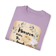 Mom's Kitchen unisex garment-dyed T-shirt for baking lovers in lavender, folded with charming kitchen-themed design.