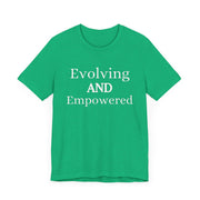 Green unisex jersey short sleeve tee with "Evolving and Empowered" text.