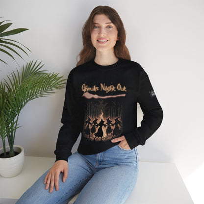 Woman wearing black Ghouls Night Out Sweatshirt with Halloween witch design sitting indoors by a plant