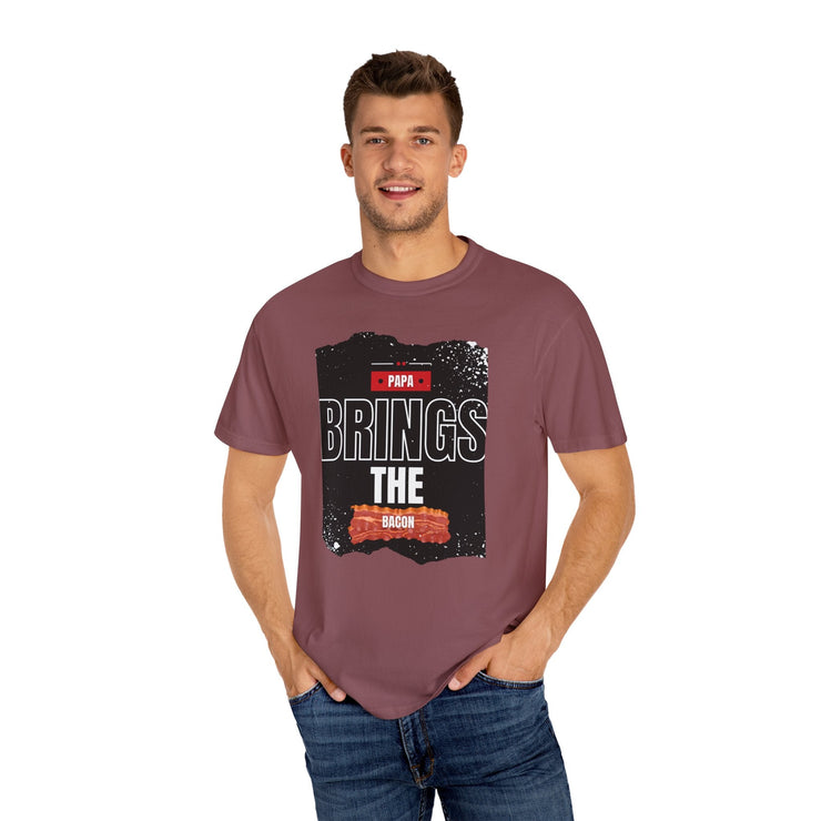 Unisex garment-dyed t-shirt with "Papa Brings the Bacon" design, perfect gift for dads, available in sizes S to 4XL.