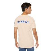 Man wearing beige "Monday" Day of the week Tee with blue varsity-style lettering on back