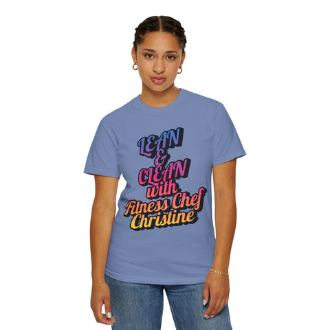 Unisex garment-dyed T-shirt in purple with "Lean & Clean with Fitness Chef Christine" print, modeled by a person, showcasing the relaxed fit and crew neckline.