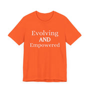 Unisex jersey short sleeve tee with "Evolving and Empowered" text in vibrant orange.