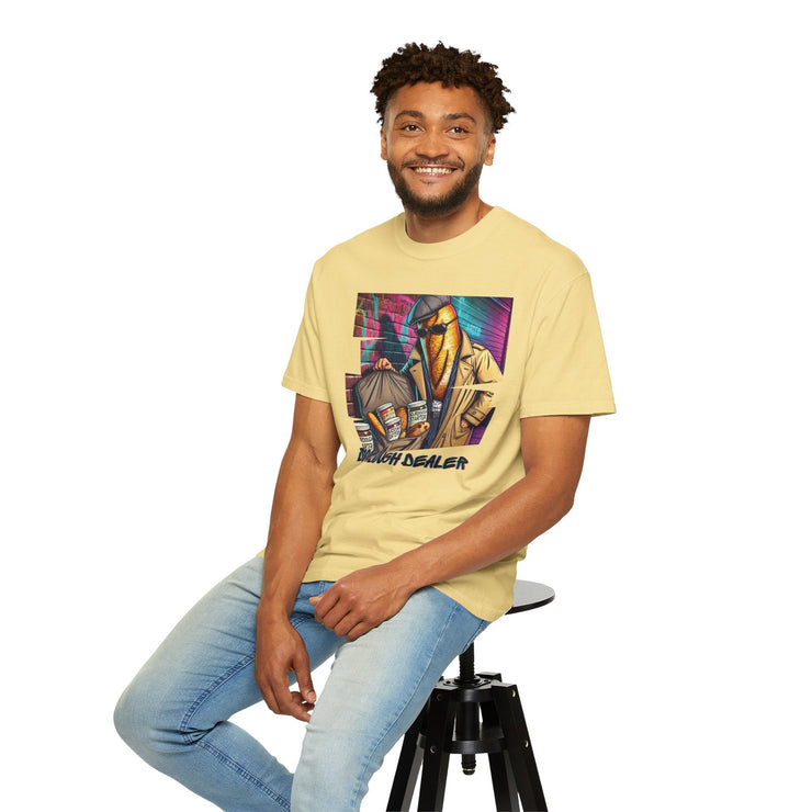 Man wearing yellow "Sourdough Dealer" T-shirt, sitting on a stool, casual style.
