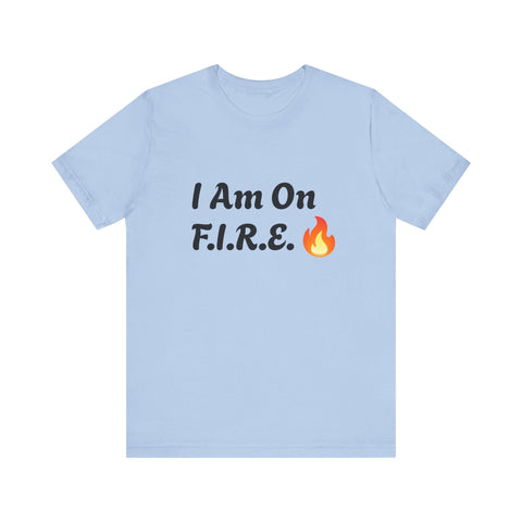 Light blue "I Am On F.I.R.E." motivational t-shirt promoting the F.I.R.E. Movement with flame graphic.
